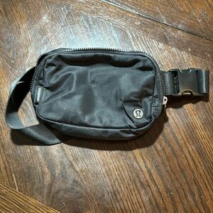 Black Lululemon Belt Bag, The Logo Is Turning A Little Bit.